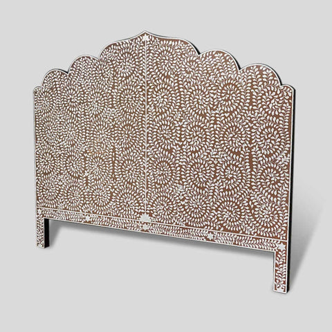 The Matrix Global Market Handmade Bone Inlay Bed & Headboard Furniture features a decorative headboard with a scalloped top edge and intricate white floral patterns on a brown background. The design showcases symmetrical, flowing vines and leaves, adding a touch of elegance to the bed furniture piece. The gray background enhances its intricate details.