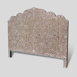 The Matrix Global Market Handmade Bone Inlay Bed & Headboard Furniture features a decorative headboard with a scalloped top edge and intricate white floral patterns on a brown background. The design showcases symmetrical, flowing vines and leaves, adding a touch of elegance to the bed furniture piece. The gray background enhances its intricate details.